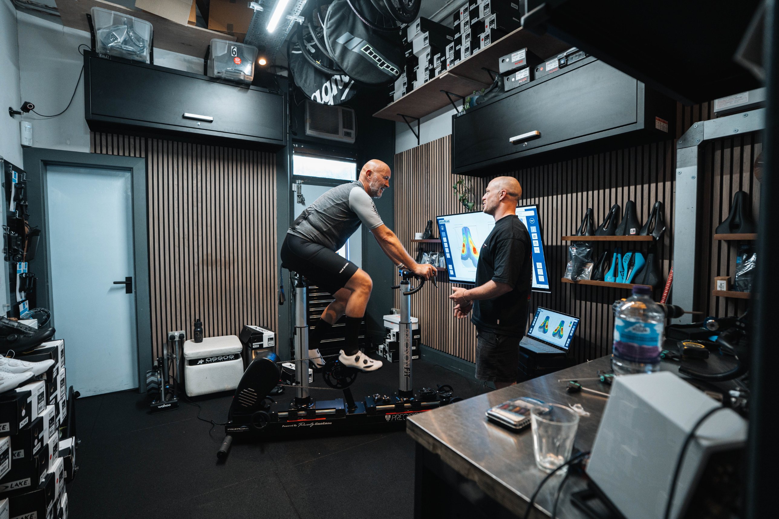 Fitter talking with a rider on the fit bike in the studio